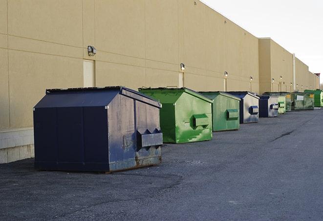 construction waste being loaded into large dumpsters in Eure